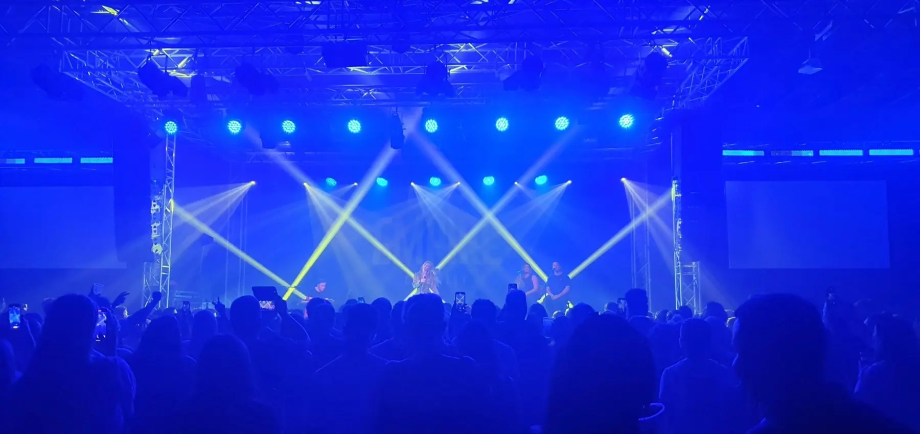 Concert audience under professional blue stage lighting